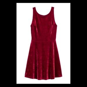 Red crushed velvet,  high-neck, low- back dress.